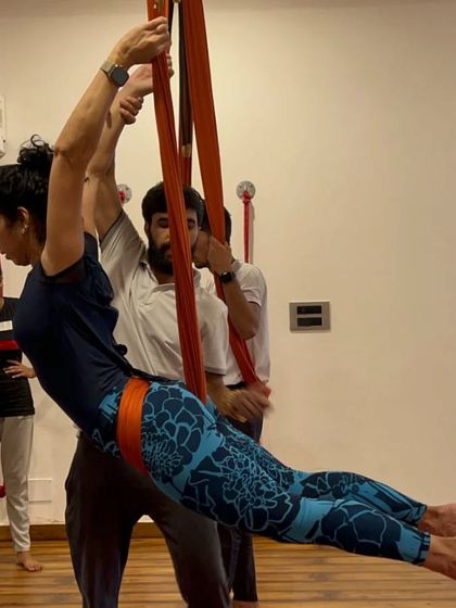During our teacher training, I provide hands-on adjustments to ensure students understand the alignment and safety of aerial poses.