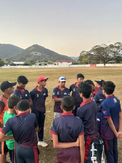 A team huddle on the field in Trinidad, a great learning experience for the young players.