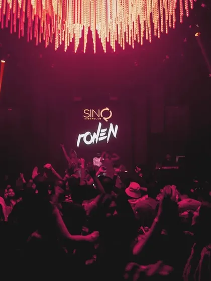 The dance floor at SinQ Nightclub under the glow of the chandelier and my logo. The atmosphere was sophisticated yet wild.