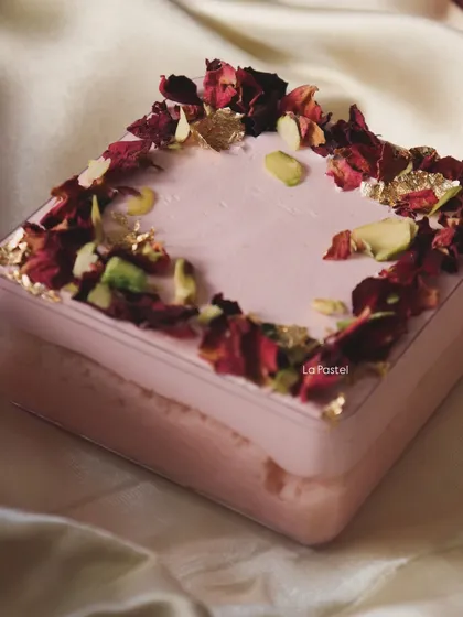 My Rose Tres Leches tub, a delicate and fragrant dessert made with rose-infused milk and topped with pistachios and edible gold.