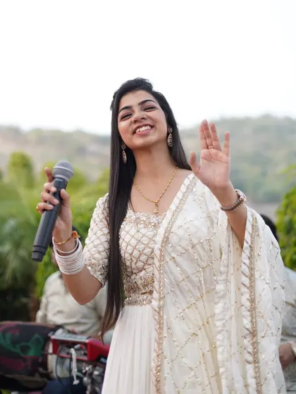 A happy wave to the audience during a performance in Udaipur. The city's royal charm added to the magic of the event.