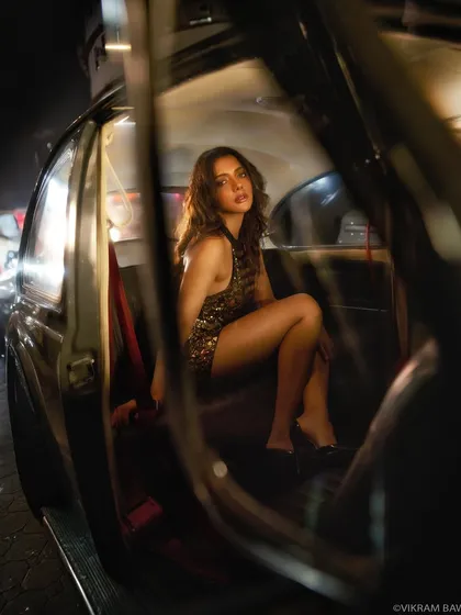 Why the hurry when all we got is time. A shot through the car door, creating a natural frame for this glamorous night-time portrait.