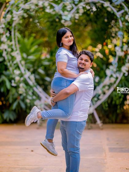 A playful and joyous moment with the groom-to-be lifting his partner.