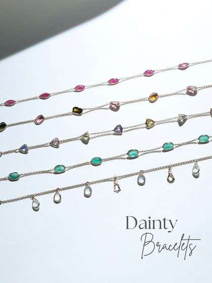 A collection of five of my dainty gold bracelets, each with its own story. This image shows the variety of gemstones available, from moonstone to ruby and emerald.