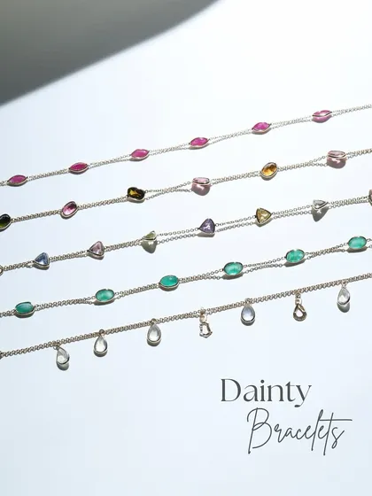 A collection of five of my dainty gold bracelets, each with its own story. This image shows the variety of gemstones available, from moonstone to ruby and emerald.