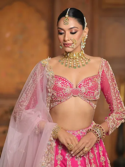 A fairytale look come to life. This close-up focuses on the soft, romantic makeup and the stunning pink lehenga, a perfect combination for a modern princess.