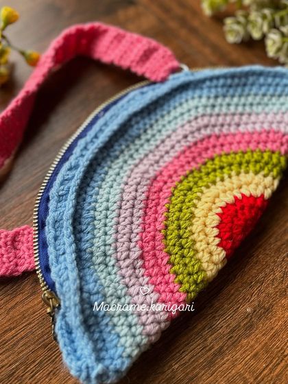 The back of the rainbow bag, showing the clean crochet stitches and the sturdy construction. It's made to withstand playful adventures.