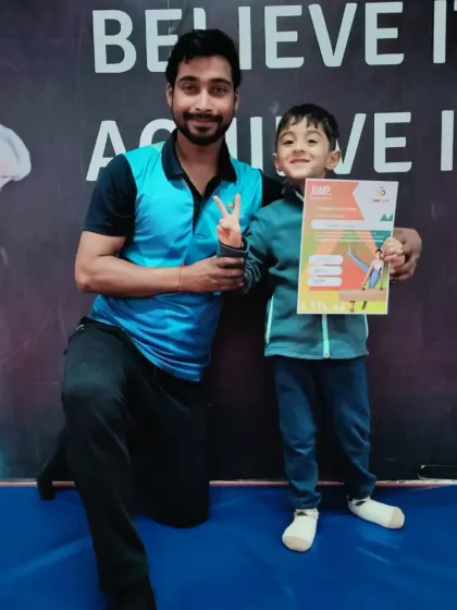 This young boy proudly holds his "JUMP" program certificate.