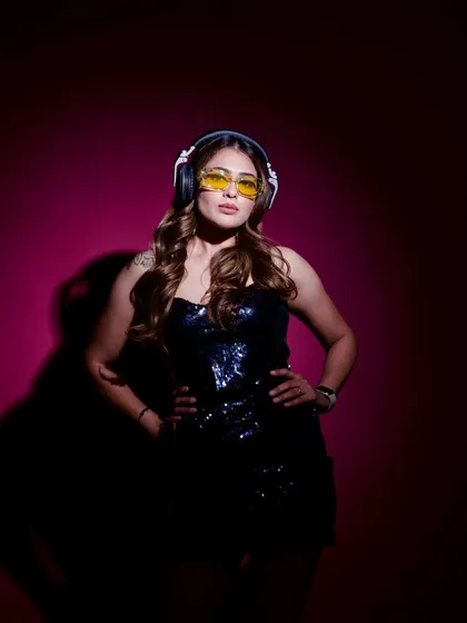 A professional portrait that captures my "BossBabe" energy. This look, complete with headphones and stylish glasses, represents the confidence and glamour I bring to my brand and every performance.