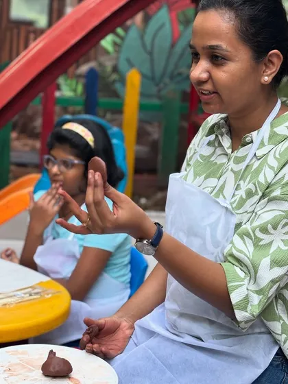 As a child psychology counsellor, I am personally involved in every session. Here, I'm demonstrating a clay modeling technique, ensuring each child feels supported and confident to explore their own creative ideas.
