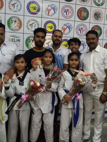 Our young female champions with their medals and bouquets at the 39th Delhi State Championship.