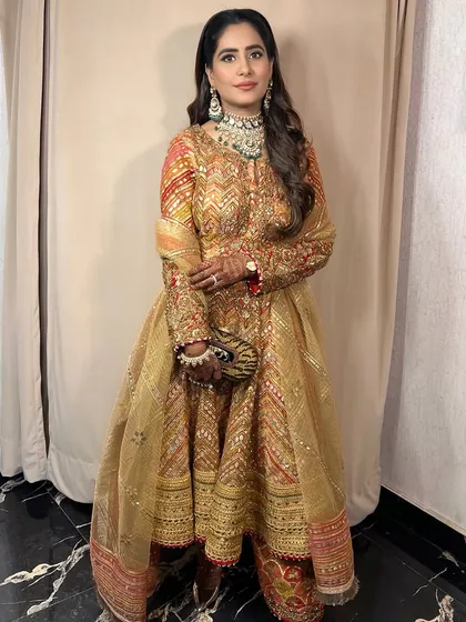 A full-length view of the client, her traditional outfit and glamorous makeup creating a stunning combination.