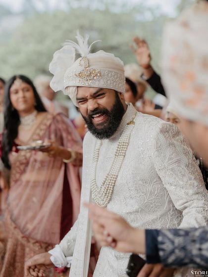 The groom's raw, joyful expression during his baraat procession, a moment of pure, unscripted celebration.