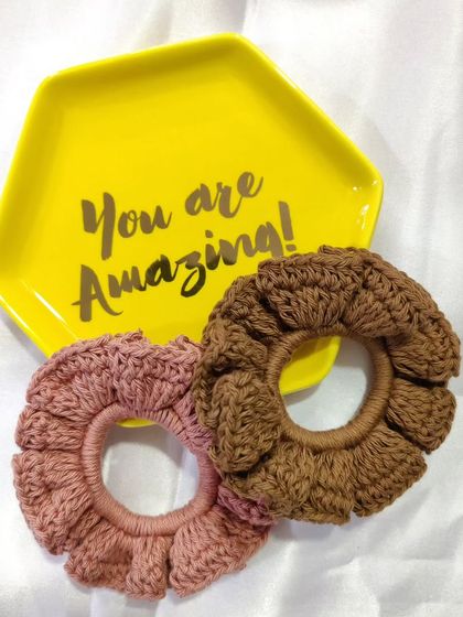 A pair of my flower-like crochet scrunchies in dusty rose and brown. They are a beautiful and practical hair accessory, handmade from soft cotton.