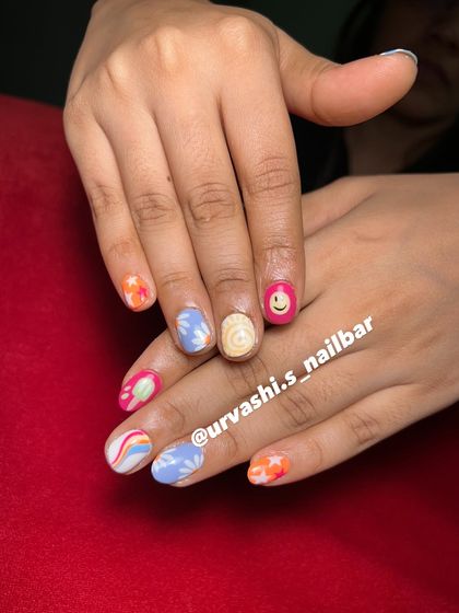 This set screams summer with its mix of fun, hand-painted designs. It includes a smiley face, rainbows, stars, and floral patterns in a bright and cheerful color palette.