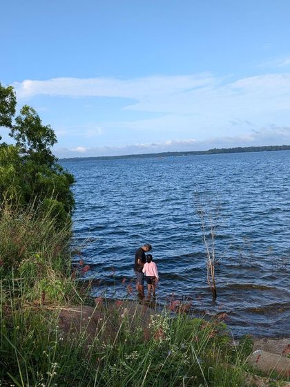 A father and daughter stand by the edge of the water at our backwater camp. It's these quiet moments of connection that make our camps special.