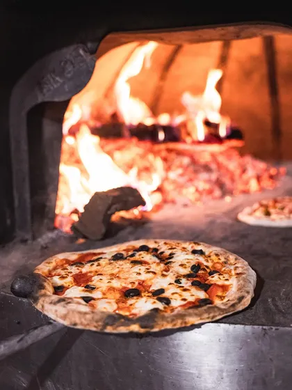A pizza baking in our mobile wood-fired oven at the Sunday Soul Sante.