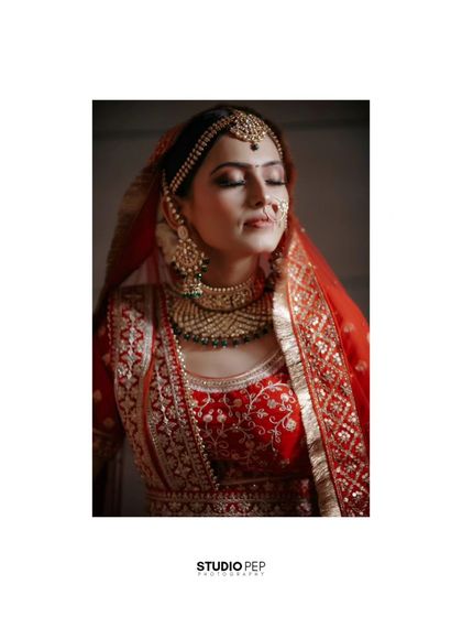 A classic, soft-lit portrait of Vaishali, her serene expression and beautiful attire making for a timeless bridal shot.