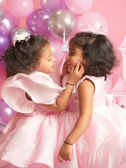 A gentle touch and a shared secret between sisters. Even in a highly themed session, I look for the quiet, authentic moments that reveal the true relationship between siblings.