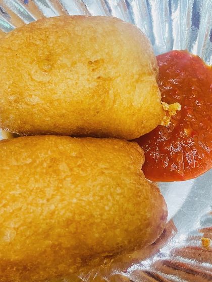 Our garma garam (hot and fresh) bread rolls. They are stuffed with a spiced potato filling and fried to golden perfection, served with a tangy tomato sauce.