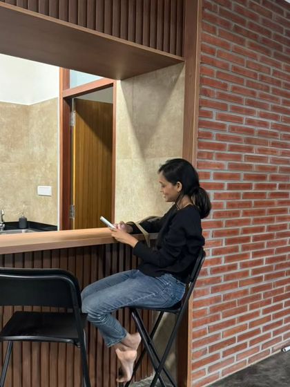 A pantry and bar counter at the Samagataorg office. The clean lines, wood paneling, and exposed brick wall demonstrate how we apply our material palette to modern commercial interiors.