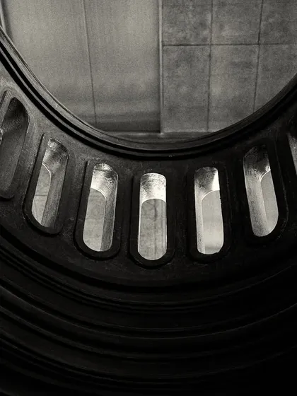 A similar abstract view of the balcony from below, creating a powerful graphic shape against the ceiling.