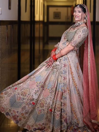A playful and happy shot of the bride, twirling in her gorgeous lehenga. This captures the fun and excitement of the wedding day.