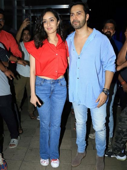 Shraddha Kapoor and Varun Dhawan at the "Stree 2" event, with her custom sneakers on full display.