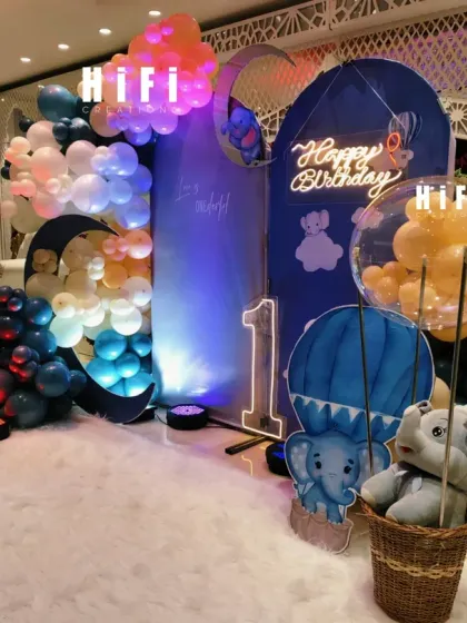 A side view of the elegant moon-themed first birthday, highlighting the layered balloon arch and props.