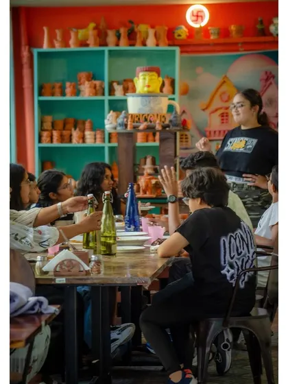 Bring your friends and make it a creative day out. This photo captures a group enjoying their time together, sharing laughs and making art in our lively cafe atmosphere.