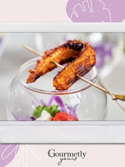 A crispy appetizer on a skewer, served in a small glass. This polaroid-style image is part of our festive collection, perfect for holiday parties.