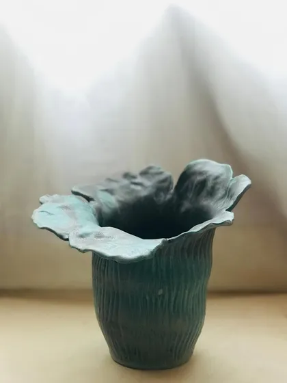 Inspired by a flower caught in a breeze, the Wild Petal Vase is hand-built to capture the beauty of nature's perfect imperfections. Its organic shape and textured surface make it a piece of art, with or without flowers.