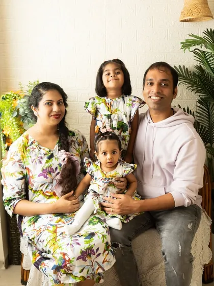 A classic family portrait taken in my Koparkhairne studio. The boho-chic setup with its white brick and natural textures provides a warm and relaxed backdrop, keeping the focus on your family's bond. We coordinated outfits for a cohesive look.