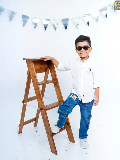 Looking cool with sunglasses, this five-year-old is a natural in front of the camera.