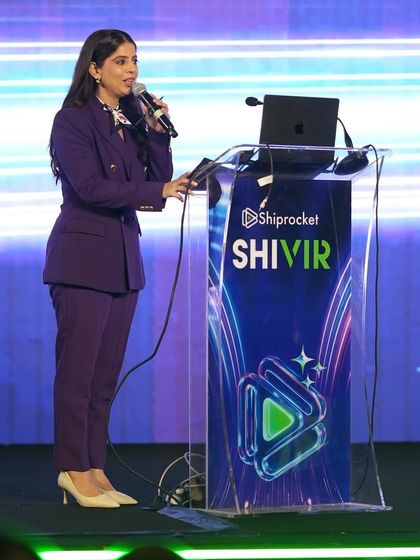 At the podium, ready to introduce the next session at Shiprocket Shivir.