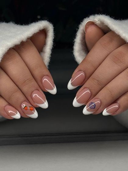 The full view of the French manicure with playful, hand-painted accents. It's a fun, summery take on a classic style.