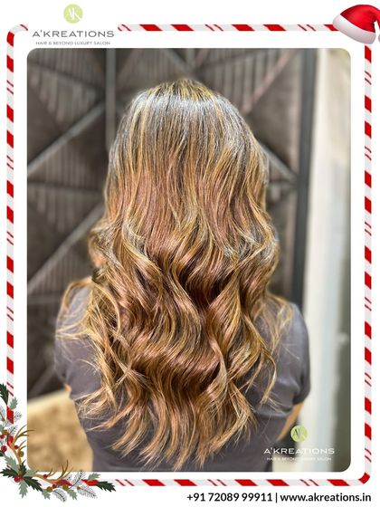 These warm, golden highlights are perfect for adding a 'wow' factor. Styled with soft waves, the hair looks voluminous, healthy, and incredibly vibrant.