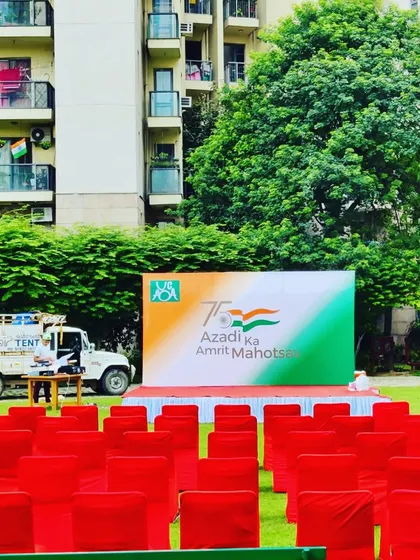 A view from the audience seats towards the main stage during an Independence Day function. This shows the scale of the event and the clear line of sight for all attendees.