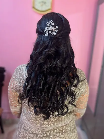 Pretty half-up curls styled on the client's own hair. I added a delicate, sparkling hair clip to add a touch of glam.