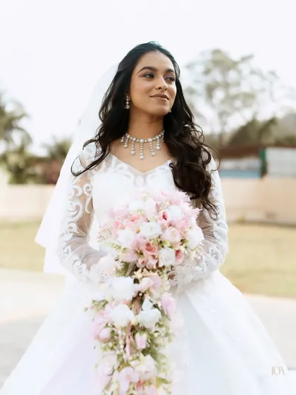 A beautiful outdoor portrait of the bride holding her cascading bouquet.