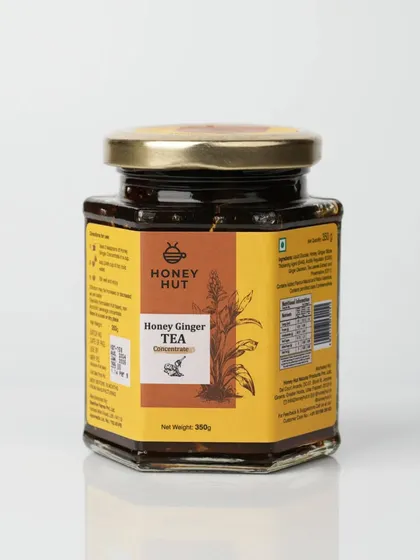 A jar of Honey Ginger Tea concentrate, photographed for an e-commerce listing. The clean reflection at the base adds a touch of professionalism.