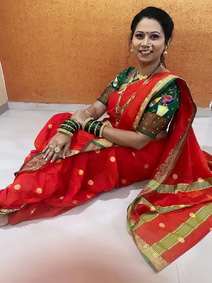 A seated pose showing the traditional way a nauvari is worn. My expertise in saree draping ensures the look is authentic and neat.