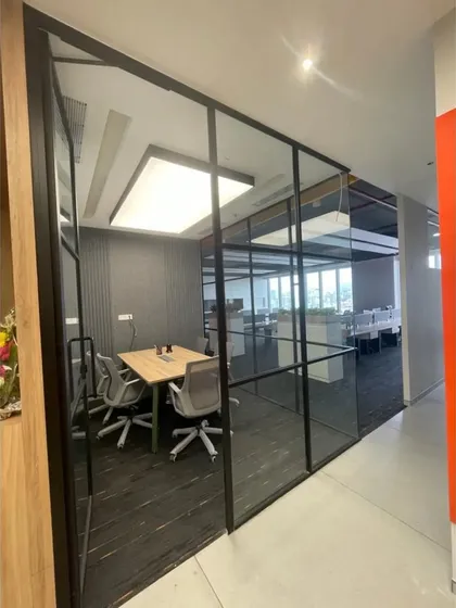 A view from the corridor into one of our glass-enclosed meeting rooms. This transparency reflects our collaborative work culture while maintaining acoustic privacy for meetings.