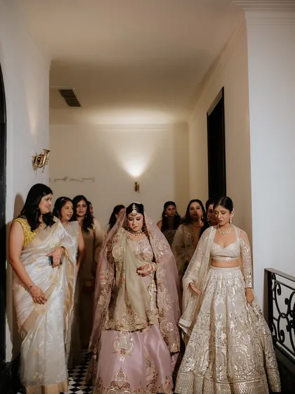 The bride's procession with her bridesmaids, a moment of support and excitement as she walks to her wedding.
