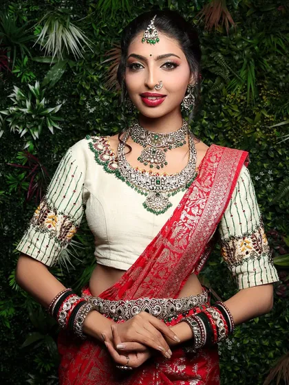 A classic bridal portrait is timeless. In this studio shot, I focused on creating a direct and engaging connection, highlighting the intricate silver jewelry and the rich texture of the red silk saree against a simple green backdrop.