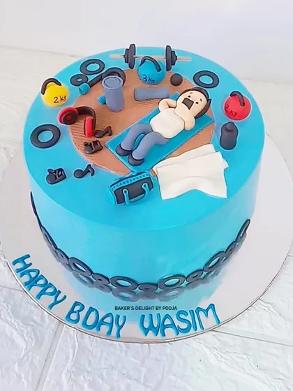 Another angle of the gym-themed cake, showing the layout of all the fun, fitness-related fondant toppers.