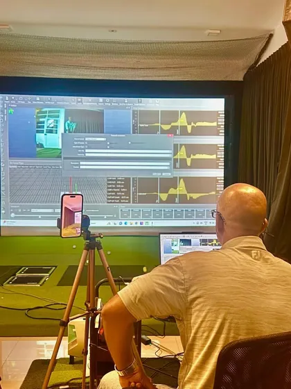 A typical setup in our performance lab, with multiple cameras and force plates capturing every aspect of the swing. This data is then analyzed to provide actionable feedback to the athlete.