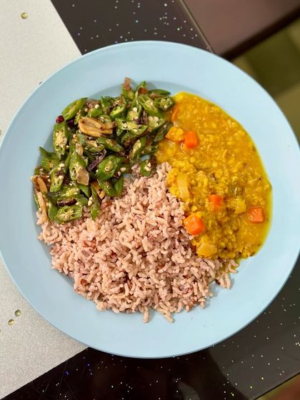 A comforting meal of red rice with dal and sautéed okra.
