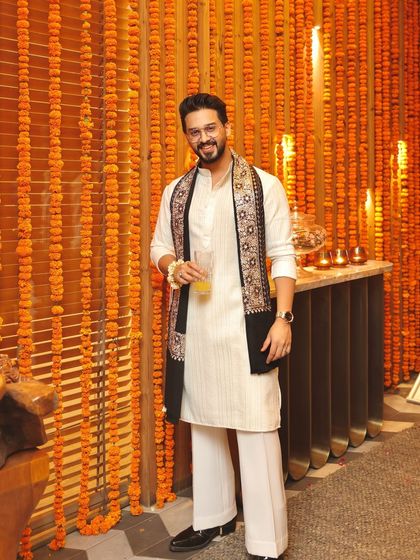 A full-length view of the client's Diwali outfit, showing the elegant drape of the embroidered stole and the classic kurta.