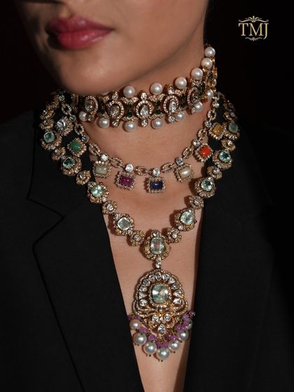 The Navratan, or nine gems, is the ultimate main character moment for a bride. This layered set combines a traditional pearl and polki choker with a vibrant Navratan necklace, creating a look that is both regal and deeply personal.